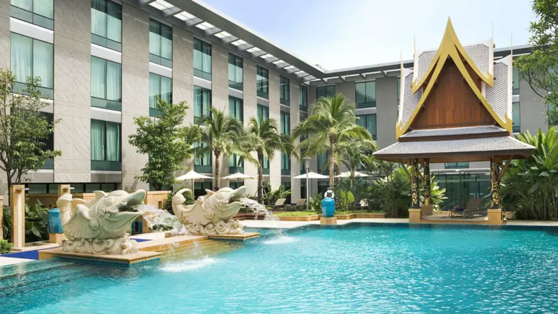Tropical outdoor swimming pool with fish sculptures at Hyatt Regency Bangkok Suvarnabhumi Airport