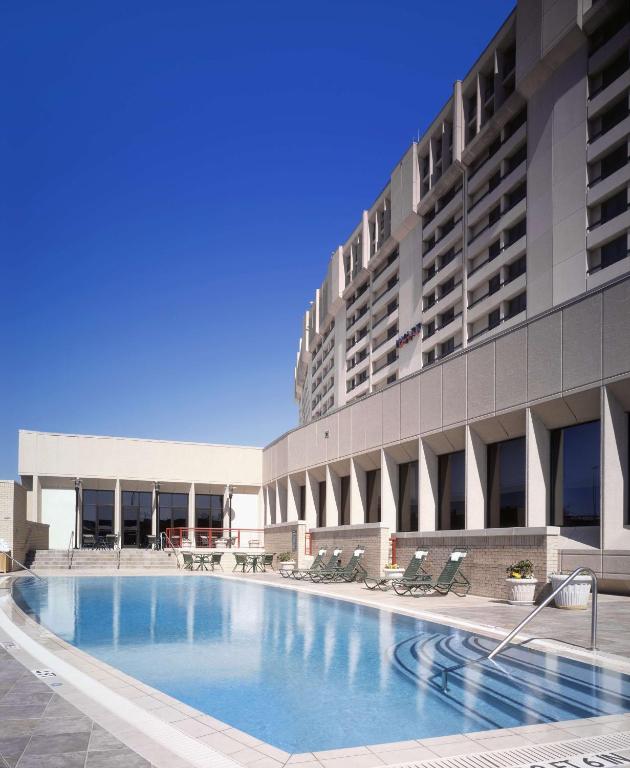 Heated outdoor swimming pool at Hyatt Regency DFW Airport adjacent to Terminal C