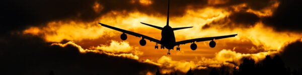 Airplane landing at sunset - Vane Airport Wellness