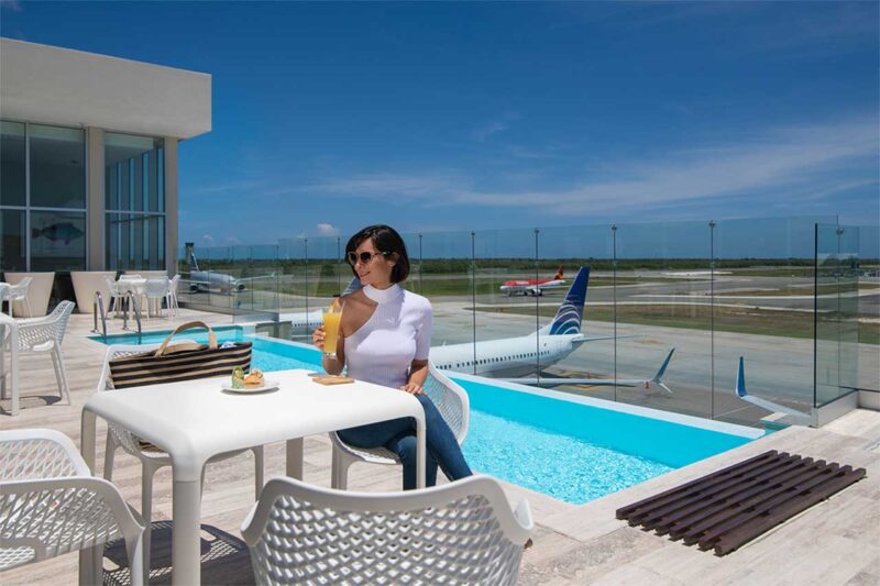 Outdoor infinity swimming pool overlooking the runway at Punta Cana International Airport VIP Lounge.