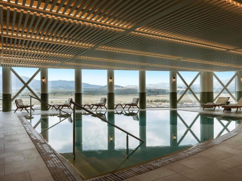 Heated indoor swimming pool with runway views at Sofitel Athens Airport Hotel