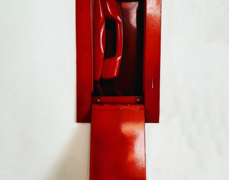 Red emergency telephone in a wall box, representing Plan B travel fixes.